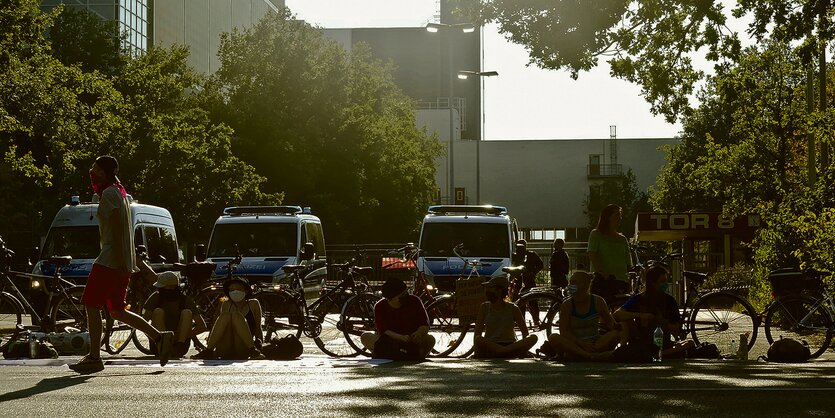 Demonstranten sitzen auf einer Straße.