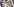 Mehrere hundert Menschen halten bei der offiziellen Gedenkveranstaltung zu den rassistisch motivierten Anschlägen in Hanau Schilder mit den Fotos von Opfern in den Händen.