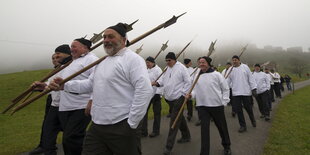 Eine Gruppe von Männern, die mit altertümlichem Kampfgerät zu