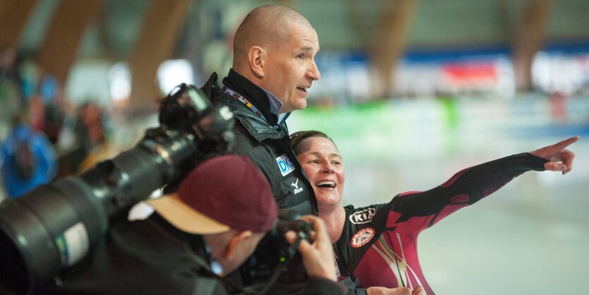 Matthias Große und Claudia Pechstein. Im Hintergrund das Innere einer Eislaufhalle