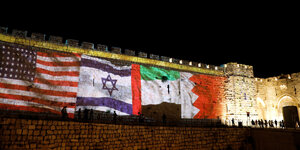Die Flaggen der USA, Israel, der arabischen Emirate und von Bahrain weirden auf die Mauer der Altstadt von Jerusalem projiziert
