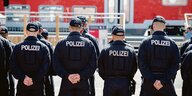 Bundespolizisten stehen auf einem Übungsgelände in Uelzen vor einem restaurierten Doppelstock-Waggon.