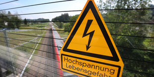 Das Bild zeigt ein Warnschild, auf dem "Hochspannung, Lebensgefahr" steht.