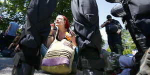 Frau mit Seifenblasen vor Polizeikette