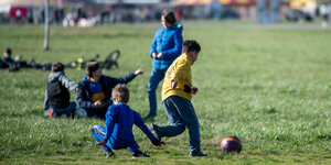 Kinder spielen auf dem Tempelhofer Feld Fußball