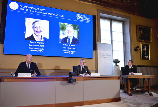 Bei einer Pressekonferenz werden zwei männer auf einer Leinwand gezeigt. Bei einer Pressekonferenz werden zwei männer auf einer Leinwand gezeigt.