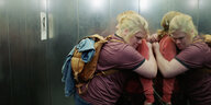 Monika und Silke umarmen sich im Fahrstuhl.