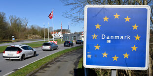 Ein Grenzschild Dänemarks mit den Europa-Sternen neben einer Autobahn