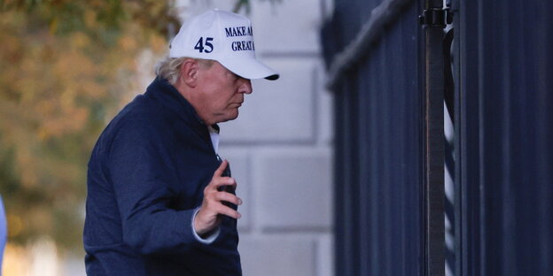 Donald Trump ist seitlich zu sehen, mit einer Kappe auf der steht "Make America great again"