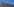 Braunes Gebäude mit dem Schriftzug "Freie Universität Berlin" im Anschnitt mit blauen Himmel im Hintergrund