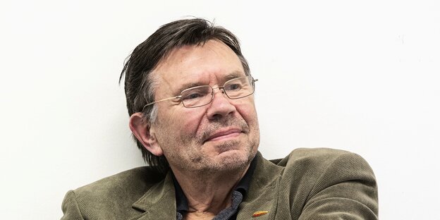 Ulf Kadritzke auf einer Veranstaltung der Hochschule fuer Wirtschaft und Recht, 2014 sitzt mit verschränkten Arnem.