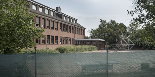 Blick auf den abgezäunten Hof und das trostlose Gebäude der Freien Evangelischen Bekenntnisschule Bremen