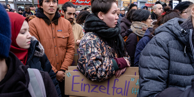 Auf einer Demonstration trägt eine Frau ein Schild mit dem Titel "Einzelfall".