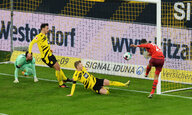 Drei Dortmunder Fußballer schauen zu, wie ein Kölner Spieler trifft