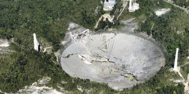 Teleskop Arecibo zerstört: In einer Luftaufnahme sieht man, wie die 900 Tonnen schwere Instrumentenplattform auf die 305 Meter breite Teleskopschüssel geknallt ist und diese zerstört hat