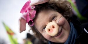 Protestlerin hat sich eine Schweinenase aufgesetzt