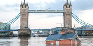 ein Haus versinkt in der Themse vor einer Brücke