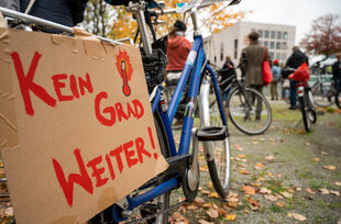 Schild an Fahrrad mit der Aufschrift "Kein Grad weiter!"