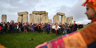Stonehenge: Menschen reichen sich die Hände, als sie sich am Steinmonument Stonehenge versammeln, um die Wintersonnenwende zu feiern und den Sonnenaufgang nach der längsten Nacht des Jahres zu erleben