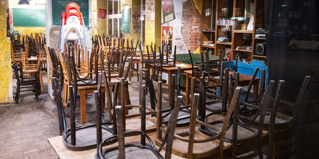 In einem geschlossenen Restaurant sind um 20 Uhr die Stühle umgedreht auf den Tischen