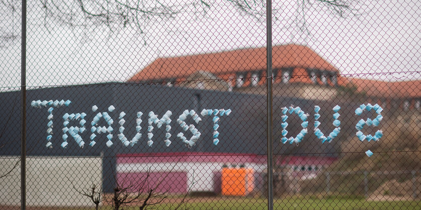 An einem Zaun hängt ein großes Band mit der Aufschrift "Träumst du?"