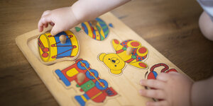 Ein Kleinkind macht ein Puzzle in einer Kita