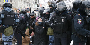 Die Polizei hält einen Mann und eine Frau fest während eines Protestes gegen die Inhaftierung des Oppositionsführers Nawalny