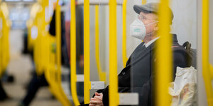 Mann mit FFP2 Maske in der U-Bahn