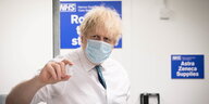 Boris Johnson hält ein Fläschchen des Impfserums von AstraZeneca in die Kamera