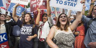 Jubelnde Menschen mit Transparenten für Obamacare