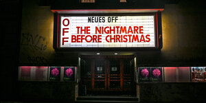 Der Eingang eines Kinos in der Nacht, die Leuchttafel kündigt "The Nightmare before Christmas" an.
