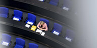 Einsame Abgeordnete neben Stuhl mit Zettel Bitte Frei Lassen auf einem Stuhl im Plenarsaal des Deutschen Bundestages