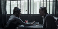 Isabel (Salma Hayek) und Greg (Owen Wilson) sitzen in einer trist-düsteren Bar.