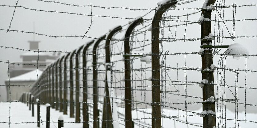 Ein Stacheldrahtzaun in schneebedeckter Landschaft