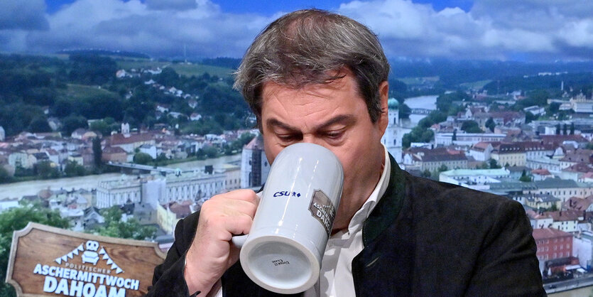 Markus Söder trinkt aus einem Bierkrug