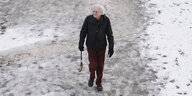 ein mann geht spazieren auf einem verschneiten weg