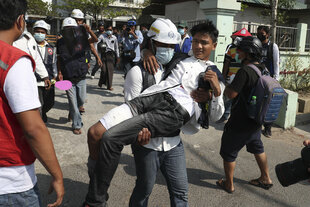 Ein Sanitäter trägt einen Verwundeten während einer Demonstration in Myanmar