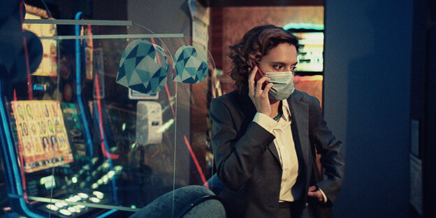Katia Pascariu trägt als Emi eine OP-Maske beim Telefonieren.
