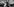 Filmausschnitt aus Mank: Die Schauspieler Gary Oldman und Amanda Seyfried rauchend am Set - hinter ihnen ein Scheinwerfer