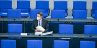 Verkehrsminister Andreas Scheuer sitzt alleine auf einem blauen Stuhl im Bundestag
