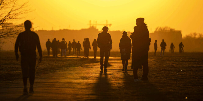 Silhouetten von Menschen im Sonnenuntergang