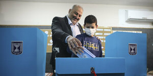 ein Mann mit einem Kind bei der Stimmabgabe