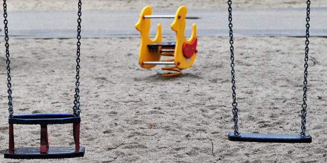 Eine Schaukel und ein Schaukelpferdchen auf einem Spielplatz