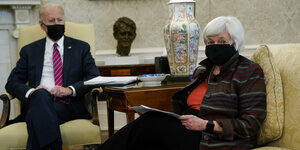 US-Präsident Biden und Janet Yellen sitzen im Weißen Haus und tragen Masken