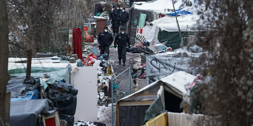 Polizisten befinden sich auf dem Gelände eines Obdachlosencamps an der Rummelsburger Bucht