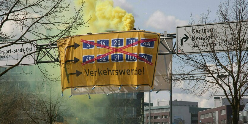 Protest auf einer schilderbrücke über einer Straße.