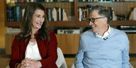 Melinda und Bill Gates sitzen auf Sesseln und lächeln sich an