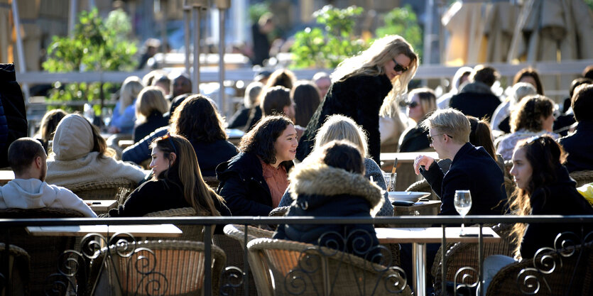 Die Menschen genießen die Sonne in einem Restaurant in Schweden