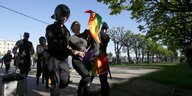 Polizisten nehmen die Teilnehmerin einer LGBTQ-Demo fest