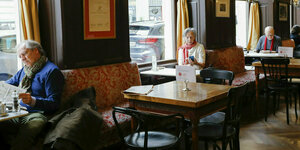 Menschen sitzen in einem altertümlichen Kaffeehaus in Wien
